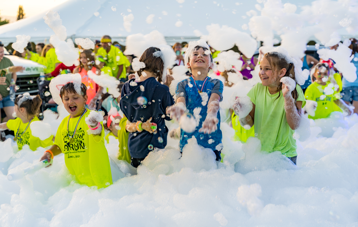 Kids running through foam at a party - Mike's Foam Parties foam party rentals Chillicothe, IL